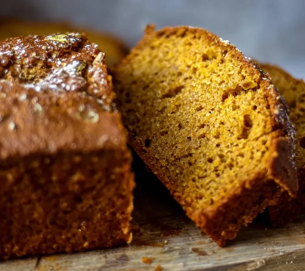 Freshly baked easy pumpkin bread recipe on a wooden table