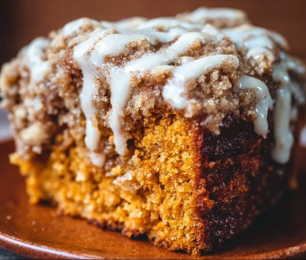 Delicious Pumpkin Coffee Cake topped with cream and spices