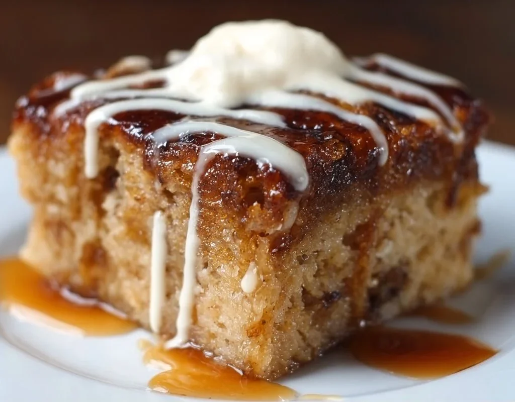 Sticky banana bread pudding cake topped with caramel sauce and bananas