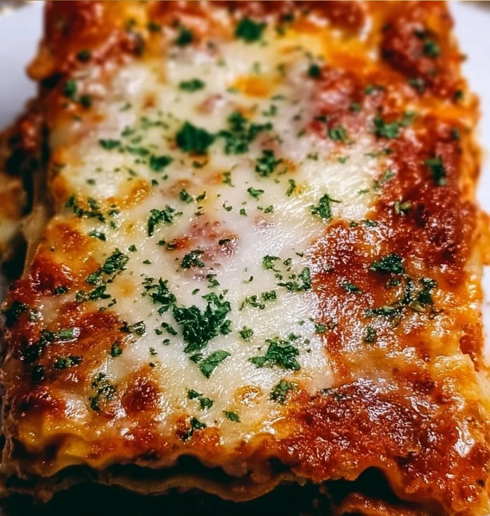 Delicious Million Dollar Lasagna served on a plate with fresh herbs