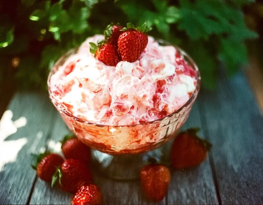 Delicious Strawberry Jello Fluff Salad with fresh strawberries and cream