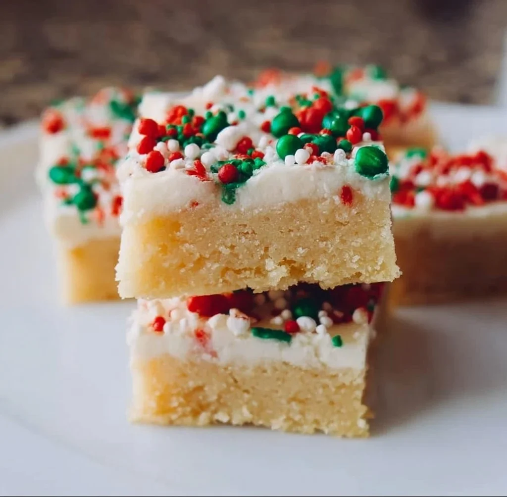 Delicious Christmas sugar cookie bars decorated with festive sprinkles