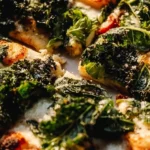 Delicious Burrata Caesar Salad Pizza topped with fresh greens and creamy burrata cheese.