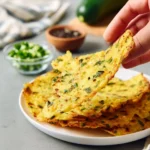 Soft zucchini taco shells on a plate with fresh toppings