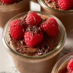 High-protein vegan chocolate mousse topped with fresh berries and mint.